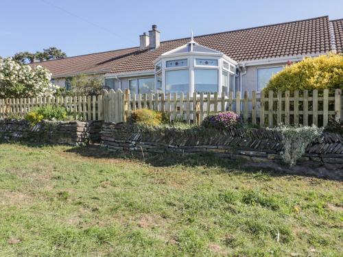 a wooden fence in front of a house at Dune Haven in Truro