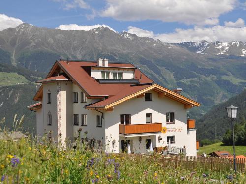 a house on a hill with mountains in the background at Apartment Ladis-7 by Interhome in Ladis