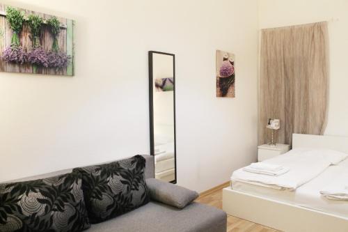 a small bedroom with a mirror and a bed at Modern Apartment Ve Smečkách 28 in Prague