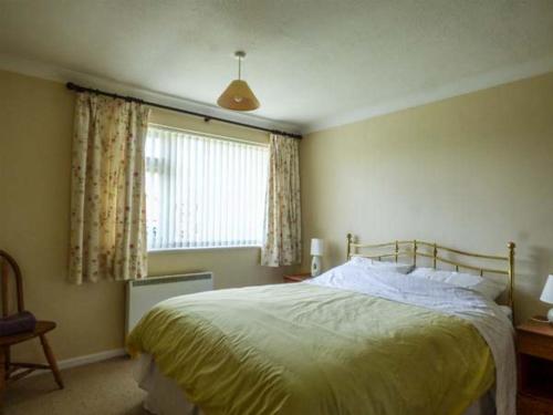 a bedroom with a large bed and a window at Skylark in Holt