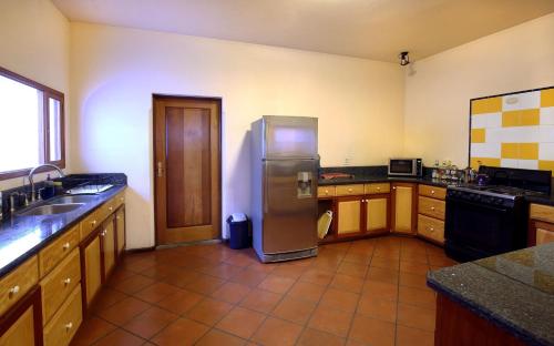 a kitchen with a stainless steel refrigerator in it at Chez Daniel in Antigua Guatemala