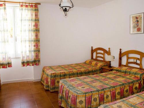 a room with two beds and a window at Apartment Masia Torrents 5 by Interhome in Segur de Calafell