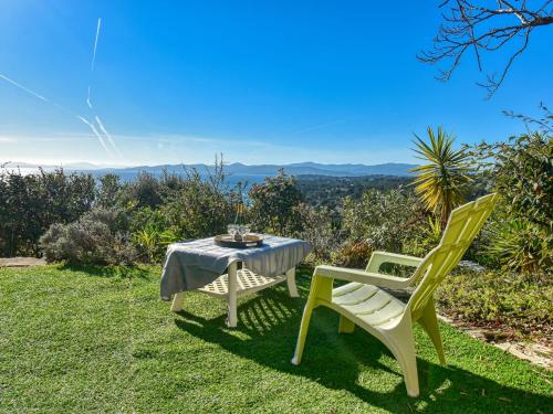 a table and two chairs sitting on the grass at Holiday Home Panorama by Interhome in Drammont
