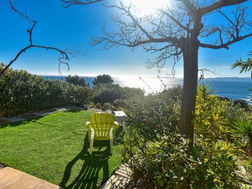 a yellow chair in a yard with a view of the ocean at Holiday Home Panorama by Interhome in Drammont