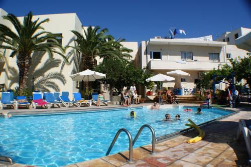 a swimming pool with people in a resort at C & A Hotel Apartments in Polis Chrysochous