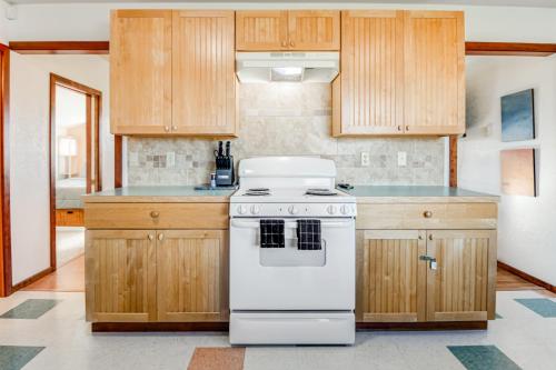 a kitchen with a white stove and wooden cabinets at Little Ocean in Ocean Park