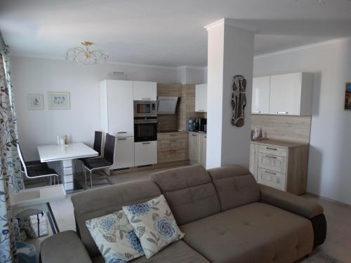 a living room filled with furniture and a coffee table at Akrotiria Beach Apart Complex in Nesebar