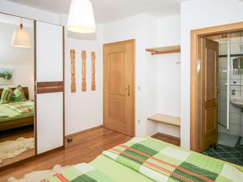 a bedroom with a bed and a bathroom with a sink at Apartment Poldi by Interhome in Haus im Ennstal