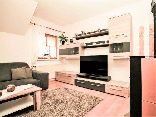 a living room with a couch and a flat screen tv at Apartment Poldi by Interhome in Haus im Ennstal