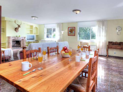 a wooden table in a living room with a dining room at Villa Macedonia by Interhome in Lloret de Mar