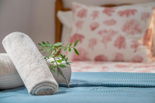 a plant in a vase sitting on a bed at Vistasol Port de Soller in Sóller
