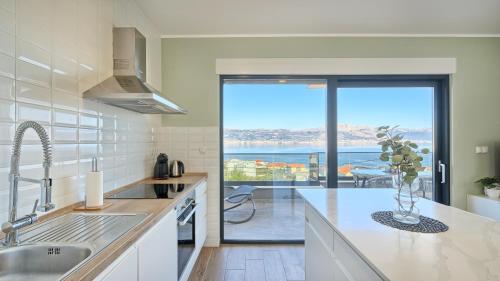 a kitchen with a view of the ocean at Apartment 4 friends Apartment Sanja in Slatine
