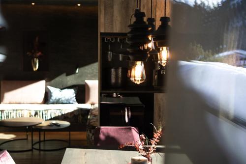 a living room with a couch and a table at Luxury Apart Sailers including Premium Summercard in Sankt Anton am Arlberg