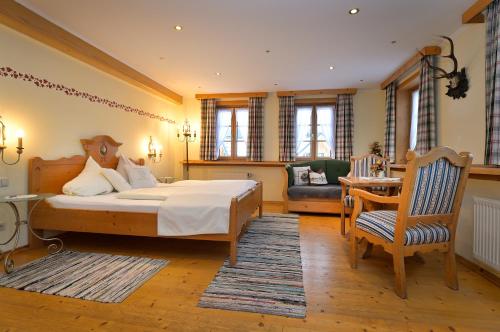 a bedroom with a bed and a chair and a table at Villa Salis in Altaussee