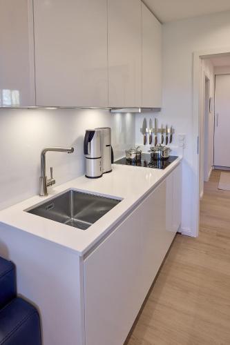 a kitchen with a sink and a counter top at KEITUM unique POOL I VIEW I GARDEN in Keitum