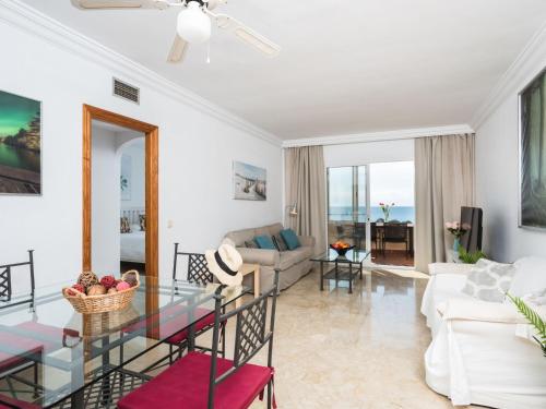 a living room with a glass table and a couch at Apartment Marina Bay-2 by Interhome in Estepona