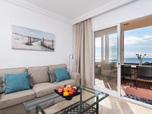 a living room with a couch and a glass table at Apartment Marina Bay-2 by Interhome in Estepona