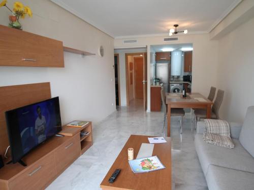 a living room with a couch and a tv at Apartment Vila Park by Interhome in Cala de Finestrat
