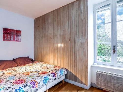a bedroom with a wooden wall next to a bed at Studio L'Abri des Flots by Interhome in Cancale