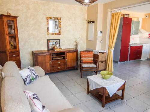 a living room with a couch and a table at Apartment Les Glycines by Interhome in Saint Cyprien Plage