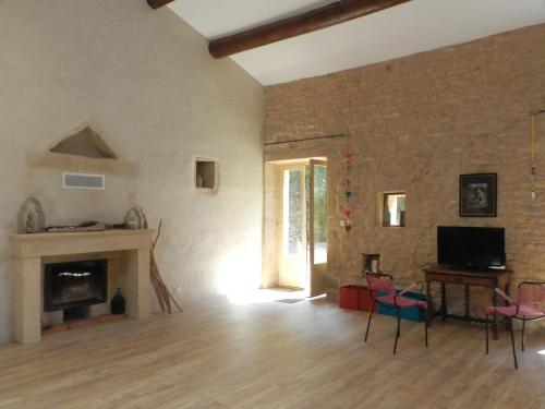 アルジエにあるHoliday Home Arbre Bouteille by Interhomeのレンガの壁のリビングルーム(暖炉付)