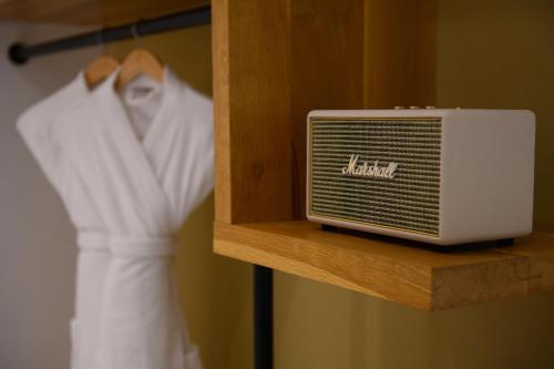 a white radiator on a shelf next to a robe at Eleals Boutique Hotel in Perama