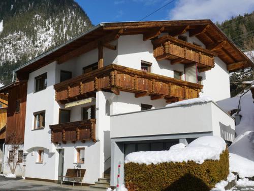 a large white building with wooden balconies at Holiday Home Hölzl by Interhome in Flirsch