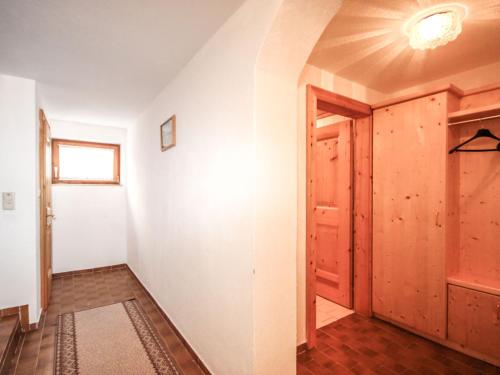 an empty hallway with a door and a window at Holiday Home Hölzl by Interhome in Flirsch