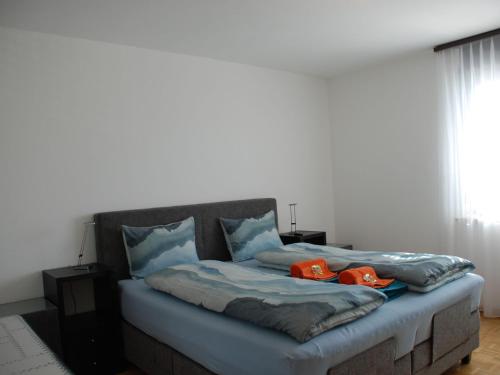 a bed with two dogs sitting on top of it at Apartment Saleggi Apt- 20 by Interhome in Locarno