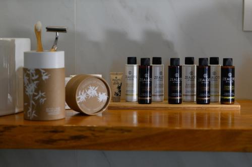 a wooden shelf with a row of books and a coffee cup at Eleals Boutique Hotel in Perama