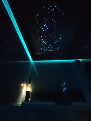 a seat in a car with blue lights in the dark at PentLux - SPA Penthouse in the heart of Skopje in Skopje