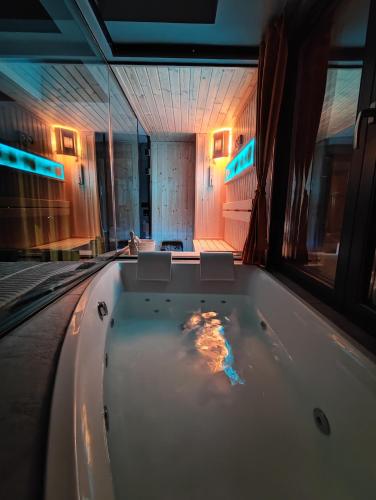 a jacuzzi tub in the middle of a room at PentLux - SPA Penthouse in the heart of Skopje in Skopje