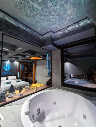 a large bath tub in a room with a bedroom at PentLux - SPA Penthouse in the heart of Skopje in Skopje