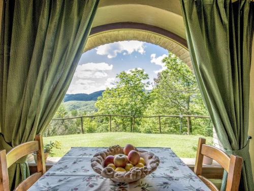 a bowl of fruit sitting on a table with a window at Holiday Home Casale Belvedere by Interhome in Roccastrada