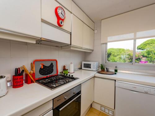 a kitchen with a stove top oven next to a microwave at Apartment Acuario by Interhome in Sant Andreu de Llavaneres