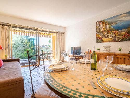 a dining room with a table with wine glasses at Apartment L'Orée de Vence by Interhome in Vence