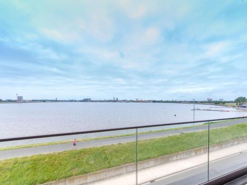 a view of the water from the balcony of a building at Apartment Lakeside by Interhome in Bredene