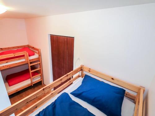 a bedroom with a bed and a bunk bed at Apartment Taubenschlag - Top 4 by Interhome in Grünau im Almtal