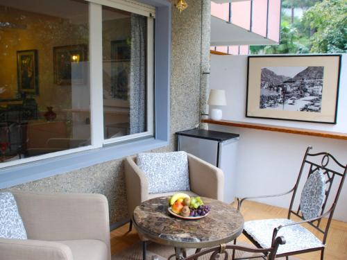 a room with a table with a bowl of fruit on it at Apartment 305 Romantik by Interhome in Bissone
