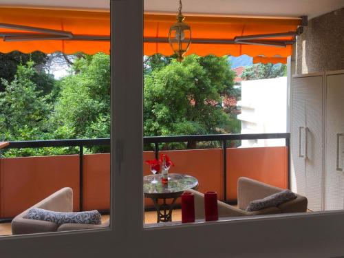 a balcony with a table and chairs and a window at Apartment 305 Romantik by Interhome in Bissone