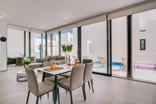 a dining room with a table and chairs at SunnyVillas: 2BR New Villa☆Private Pool in Pernera - Nicholas in Protaras