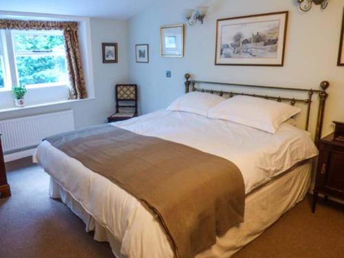a bedroom with a large bed and a window at Clock View in Haworth