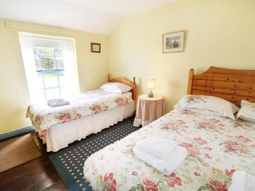 a bedroom with two beds and a window at Callaghan's in Kilkeel