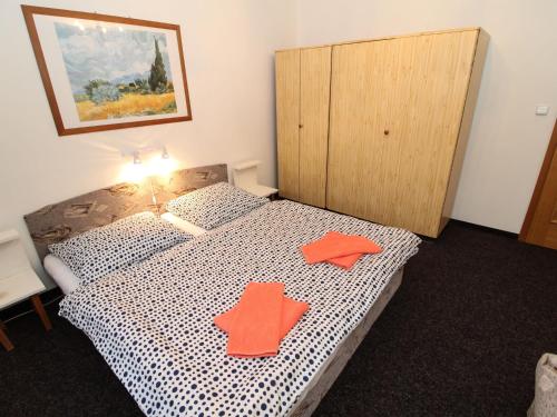 um quarto com uma cama com duas estrelas laranja em Apartment Lanovka-2 by Interhome em Jáchymov