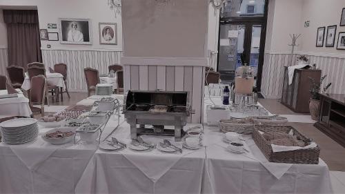 a white table with plates and dishes on it at Hotel Vojvodina in Novi Sad