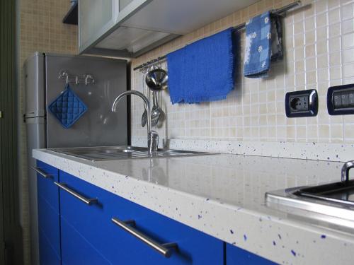 a kitchen with a sink and a refrigerator at Kalote' On The Roof Apartments in Noto
