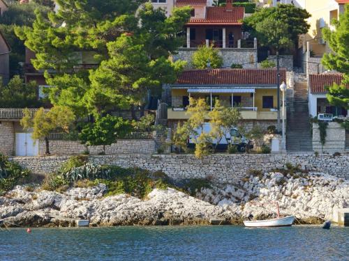 a house on the shore of a body of water at Holiday Home Peter by Interhome in Prigradica
