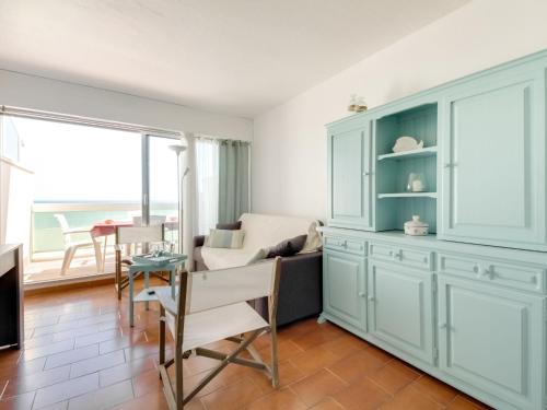 a living room with a couch and a table at Apartment Les Jardins de la Plage by Interhome in Canet-en-Roussillon