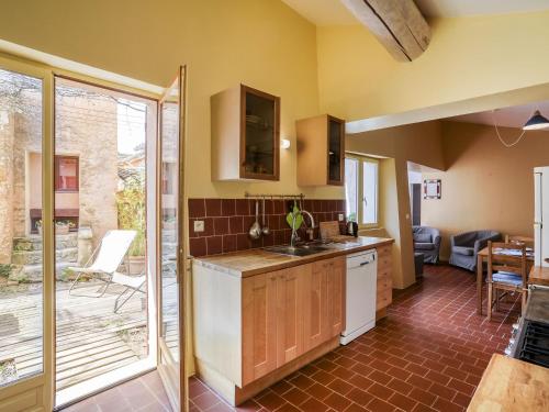 a kitchen with a sink and a counter at Holiday Home Le Puits Du Geai-2 by Interhome in Saint-Saturnin-dʼApt