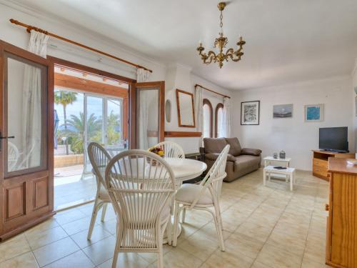 a living room with a table and chairs and a couch at Holiday Home Peeters by Interhome in Calpe